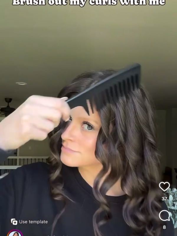 A customer brushing her hair with a 5 Birds brush