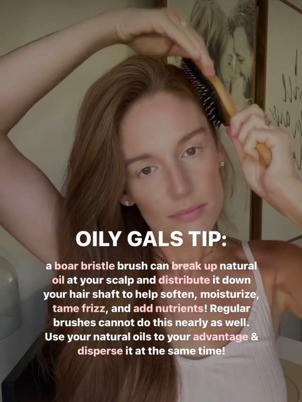 A customer brushing her hair with a 5 Birds brush